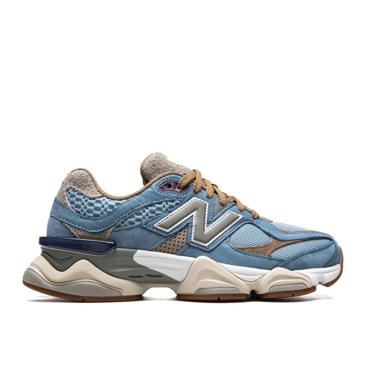 Blue and grey New Balance sneaker with an N logo and chunky cream sole, shown from the side.