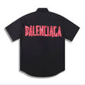 Balenciaga Short-Sleeve Shirt: A short-sleeve collared shirt with a large contrasting Balenciaga graphic on the back