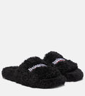 Balenciaga Slides: Open-toe slides with a textured upper and contrasting logo details