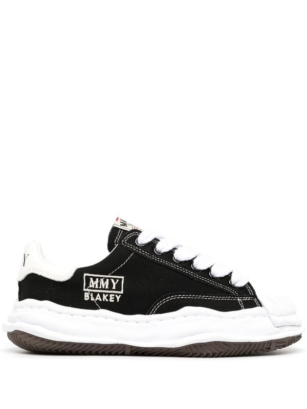 Maison Mihara Blakey Sneakers: A black low-top sneaker with contrasting white laces, visible stitching and a sculpted white sole