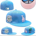 New Era LA Fitted Cap – Light Blue: A light-blue fitted cap with contrasting LA embroidery, side detailing and a pink underside to the peak