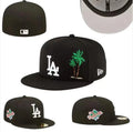New Era LA Palm Tree Fitted Cap: A dark fitted cap with white LA embroidery and a green palm-tree graphic