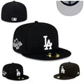 New Era LA Fitted Cap – Black: A black fitted cap with a white LA emblem, flat peak and side embroidery