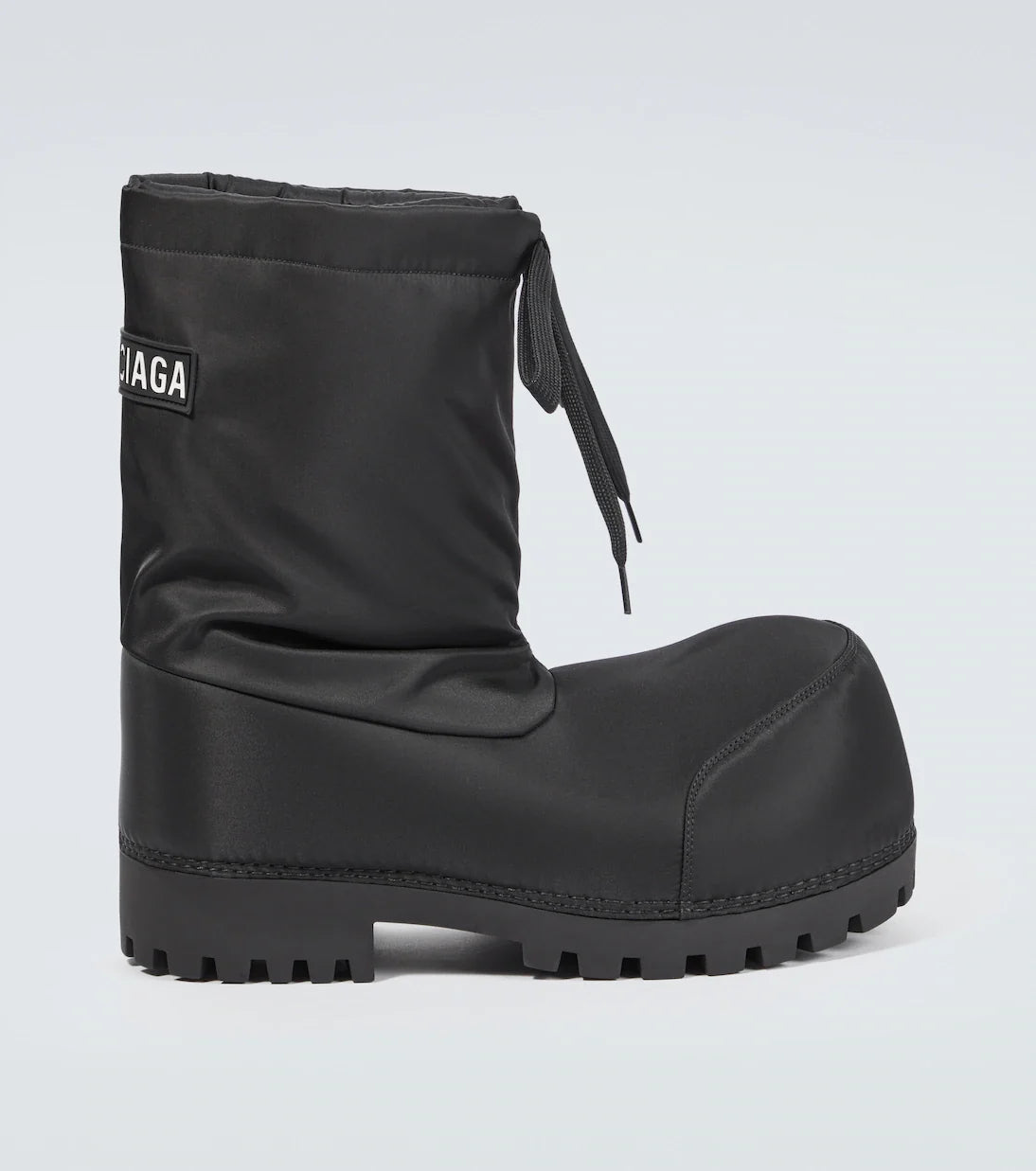 Balenciaga Alaska Boots: Dark boots with a tall, roomy shaft, side tie detail and a chunky treaded sole