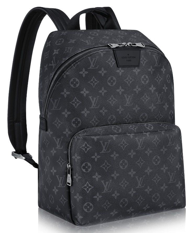 Louis Vuitton Monogram Backpack: A dark monogram backpack with a top handle, shoulder straps and a front zip compartment